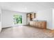 Spacious basement featuring a wet bar, granite countertops, and sliding door access to the backyard at 2027 Marquesas Ave, Tega Cay, SC 29708