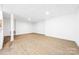 Spacious finished basement features laminate flooring, white walls and a drop ceiling at 2027 Marquesas Ave, Tega Cay, SC 29708