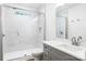 Bathroom showcasing a tiled shower with glass doors, a toilet, and a gray vanity at 2027 Marquesas Ave, Tega Cay, SC 29708