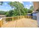Spacious wooden deck with wooden railing overlooking lush trees and neighborhood houses at 2027 Marquesas Ave, Tega Cay, SC 29708