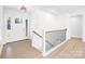 Bright foyer featuring a white front door, staircase with railing, and durable laminate flooring at 2027 Marquesas Ave, Tega Cay, SC 29708