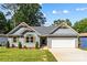 Charming single-story home with light grey siding, wooden accents and a well-manicured lawn at 2027 Marquesas Ave, Tega Cay, SC 29708