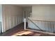 Hallway with a staircase and wooden railing plus modern paneled walls and a neutral color scheme at 2027 Marquesas Ave, Tega Cay, SC 29708
