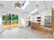 Bright kitchen with white cabinets, a center island, stainless steel appliances, and access to a deck at 2027 Marquesas Ave, Tega Cay, SC 29708