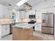 Modern kitchen with white cabinetry, stainless steel appliances, and a light wood center island at 2027 Marquesas Ave, Tega Cay, SC 29708