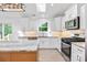 Well-lit kitchen with white cabinets, stainless steel appliances, and a center island at 2027 Marquesas Ave, Tega Cay, SC 29708