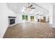 Spacious living room with fireplace, skylights, wood floors, and open access to the kitchen at 2027 Marquesas Ave, Tega Cay, SC 29708