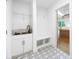 Mudroom with patterned floors, a sink, and built-in bench, leading into the kitchen at 2027 Marquesas Ave, Tega Cay, SC 29708
