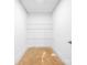 A white storage room with open metal shelving and a concrete floor at 2027 Marquesas Ave, Tega Cay, SC 29708
