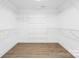 Spacious walk-in closet with shelving and wood flooring at 2027 Marquesas Ave, Tega Cay, SC 29708