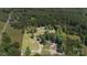 Expansive property featuring a home, a pond, wooded area, and outbuildings, offering privacy and natural beauty at 2291 Howell Rd, Midland, NC 28107