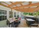 Spacious back porch featuring comfortable seating, a hot tub, and tranquil views of the surrounding landscape at 2291 Howell Rd, Midland, NC 28107