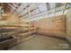 Well-maintained barn interior with wooden stalls and livestock fixtures, ready for agricultural use and animal care at 2291 Howell Rd, Midland, NC 28107