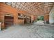 Spacious barn interior featuring wooden stalls and a metal roof, perfect for equestrian or agricultural use at 2291 Howell Rd, Midland, NC 28107