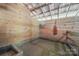 Rustic barn interior featuring wooden walls, and functional livestock amenities, great for agricultural purposes at 2291 Howell Rd, Midland, NC 28107