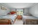 Bright bedroom featuring two twin beds, warm natural light, and neutral walls, offering a cozy atmosphere at 2291 Howell Rd, Midland, NC 28107