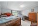 Serene bedroom featuring a large bed, dresser, and soft natural light, creating a peaceful retreat at 2291 Howell Rd, Midland, NC 28107