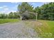 View of a metal carport with a vehicle parked inside, surrounded by a grassy field at 2291 Howell Rd, Midland, NC 28107