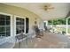 Inviting covered porch featuring rocking chairs and a view of the well-manicured landscaping at 2291 Howell Rd, Midland, NC 28107