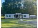 Charming home featuring a cozy front porch, well-maintained lawn, and a convenient storage shed in the backyard at 2291 Howell Rd, Midland, NC 28107