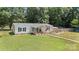 Aerial shot of a charming home featuring a cozy front porch and well-maintained lawn, perfect for outdoor enjoyment at 2291 Howell Rd, Midland, NC 28107