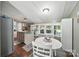 Kitchen blending with the dining area, featuring stainless steel appliances, and plenty of natural light at 2291 Howell Rd, Midland, NC 28107