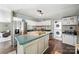 Well-lit kitchen with a functional island, stainless steel refrigerator, and convenient laundry area at 2291 Howell Rd, Midland, NC 28107