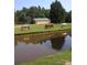 Picturesque pond with horses grazing peacefully in the background on a beautiful farm landscape at 2291 Howell Rd, Midland, NC 28107