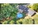 Aerial view of a private backyard with an above-ground pool, deck, and surrounding trees at 240 China Grove Rd, China Grove, NC 28123