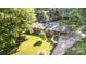 Aerial view of a brick home showcasing a well-kept lawn, lush greenery, and an above-ground pool at 240 China Grove Rd, China Grove, NC 28123