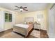 Bedroom with neutral wall color, ceiling fan, hardwood floors, and bright window at 240 China Grove Rd, China Grove, NC 28123