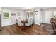 Dining area with wood flooring, a chandelier, and views of the adjacent living area and kitchen at 240 China Grove Rd, China Grove, NC 28123
