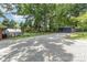 Long gravel driveway leading to a greenhouse and detached two car garage at 240 China Grove Rd, China Grove, NC 28123