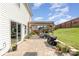 A backyard featuring an outdoor seating area with a pergola, stone flooring, and a lush green lawn at 2636 Forest Grove Ct, Charlotte, NC 28269