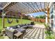 A backyard with a pergola and outdoor seating for entertaining, plus a grass lawn and wood fence at 2636 Forest Grove Ct, Charlotte, NC 28269
