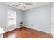 A light blue bedroom with a window and a wooden floor, featuring a ceiling fan at 2636 Forest Grove Ct, Charlotte, NC 28269
