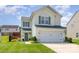 Charming two-story home featuring a well-maintained lawn, green shutters, and a two-car garage at 2636 Forest Grove Ct, Charlotte, NC 28269