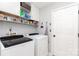 Laundry room with washer, dryer, shelving and white cabinets at 2636 Forest Grove Ct, Charlotte, NC 28269