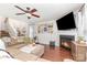 Comfortable living room featuring hardwood floors, fireplace, and a large wall-mounted TV at 2636 Forest Grove Ct, Charlotte, NC 28269
