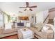 Spacious living room with a large sectional sofa, hardwood floors, and open access to the kitchen at 2636 Forest Grove Ct, Charlotte, NC 28269