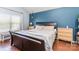 Main bedroom featuring hardwood floors, a blue accent wall and bright natural light at 2636 Forest Grove Ct, Charlotte, NC 28269