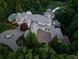 A serene aerial view showing the house's layout and surrounding greenery, basketball court, and circular driveway at 2926 Crane Rd, Waxhaw, NC 28173
