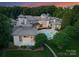 A tranquil swimming pool with an adjoined spa surrounded by pristine landscaping and architectural columns on the patio at 2926 Crane Rd, Waxhaw, NC 28173