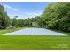 Bright blue basketball court adjacent to mature trees at 2926 Crane Rd, Waxhaw, NC 28173