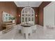 Dining room featuring an arched window, marble floors, and decorative wall sconces, perfect for intimate gatherings at 2926 Crane Rd, Waxhaw, NC 28173