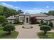 View of a luxury home's entrance with an elegant circular driveway and lush landscaped front yard with a fountain at 2926 Crane Rd, Waxhaw, NC 28173