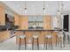 Modern kitchen with granite counters, stainless steel appliances, and a curved breakfast bar perfect for dining and entertaining at 2926 Crane Rd, Waxhaw, NC 28173