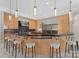 Modern kitchen with granite counters, stainless steel appliances, and a curved breakfast bar perfect for dining and entertaining at 2926 Crane Rd, Waxhaw, NC 28173