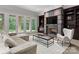 Cozy living room with fireplace, built-in shelving, plush seating, and french doors leading to outdoor views at 2926 Crane Rd, Waxhaw, NC 28173