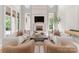 An elegant living room boasts a fireplace, lots of light, and stylish decor for comfortable living and entertaining at 2926 Crane Rd, Waxhaw, NC 28173